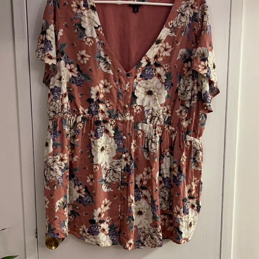 Pink top with white and green floral detailing